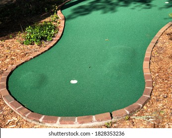 Miniature Golf Putting Green Surface With Artificial Turf And Cup.