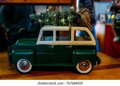 Miniature Green Station Wagon With Christmas Tree Tied To Top