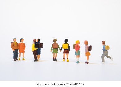 miniature group of school children with school bag on white background - Shutterstock ID 2078681149