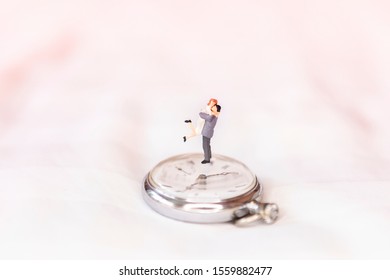 Miniature Happy Couple On Vintage Watch Over Blurred Background, Wedding And Aniversary Concept, Happy Time