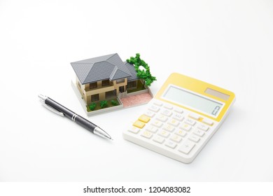 the miniature of the house and calculator - Shutterstock ID 1204083082