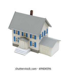 A Miniature House Isolated On A White Background.