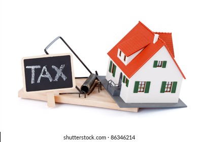 Miniature House In Mousetrap Of Taxes, Concept