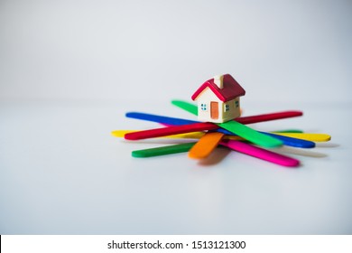 Miniature House On Popsicle Stick On White Background