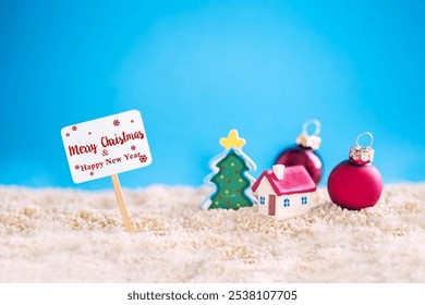 miniature house with red roof on tropical sand beach and decoration Christmas tree. - Powered by Shutterstock