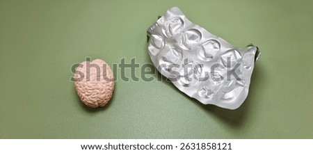 Miniature Human Brain with Empty Blister Pack – Concept of Mental Health, Medication, Psychiatric Treatment, Depression, Addiction, and Cognitive Disorder. 