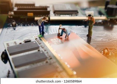 Miniature Mini  Figures Technician Repairing And Verify Credit Card Inside Of Integrated Circuit. The Concept Of Data, Hardware, Technician And Technology. Data  Security