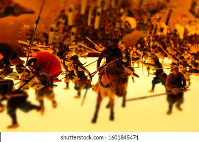 Miniature model figures depicting Siege of Osaka, battling Japanese samurai warriors on horseback with weapons, macro close up