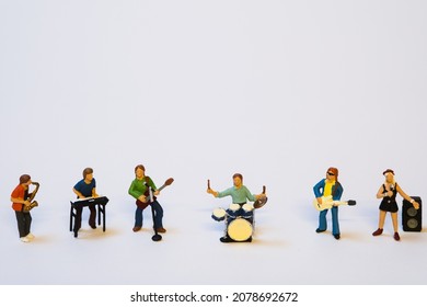 miniature music band making music on white background - Shutterstock ID 2078692672