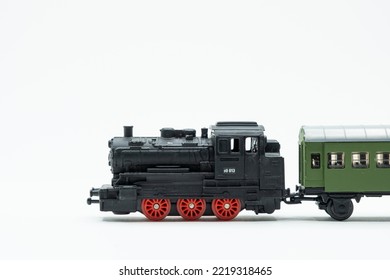 Miniature Of An Old Toy Train, A Black Locomotive With A Green Wagon. Scale 1:120. A Vintage Toy From The '80s.