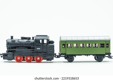 Miniature Of An Old Toy Train, A Black Locomotive With A Green Wagon. Scale 1:120. A Vintage Toy From The '80s.