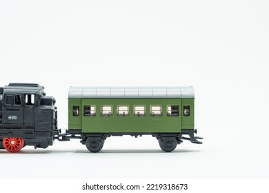 Miniature Of An Old Toy Train, A Black Locomotive With A Green Wagon. Scale 1:120. A Vintage Toy From The '80s.