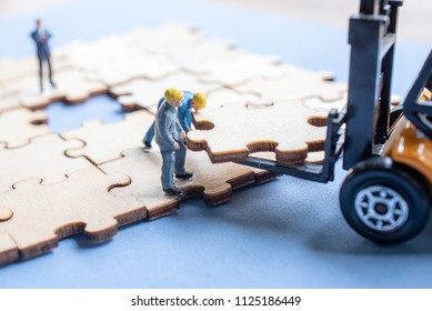 Miniature on wood jigsaw, Business concept - Powered by Shutterstock