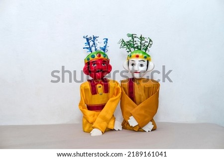 Miniature ondel ondel puppet figure at white isolated background. Ondel-ondel  is a large puppet figure featured in Betawi folk performance of Jakarta, Indonesia. Ondel-ondel is an icon of Jakarta. 