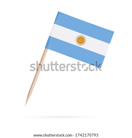 Miniature paper flag Argentina. Isolated Argentinian toothpick flag stick on white background. With shadow below.