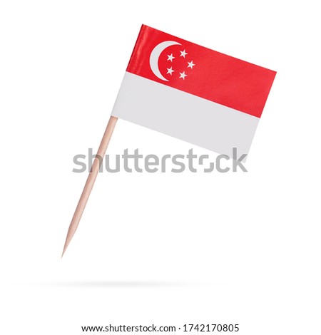 Miniature paper flag Singapore. Isolated Singaporean toothpick flag stick on white background. With shadow below.