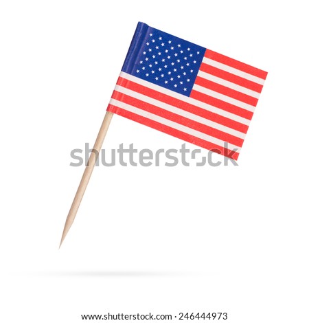 Miniature paper flag USA. Isolated American Flag on white background. With shadow below
