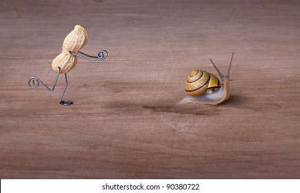 Miniature With Peanut Man Trying To Catch A Snail