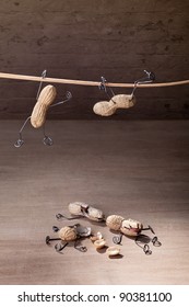 Miniature with Peanut People trying to hold their balance and grasping for a straw - Shutterstock ID 90381100