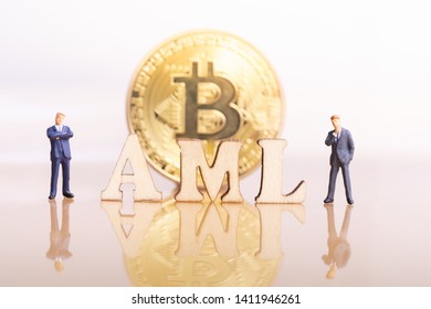 Miniature People: Bitcoin And Wood Block Word AML.  Bitcoin Money Laundering Concept. Anti Money Laundering. Blockchain Technology. 