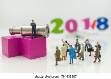 Miniature people: Business man standing on wood block with binoculars and wood number 2018 using as background Choice of the best suited employee, HR, HRM, HRD, job recruiter concepts. - Powered by Shutterstock