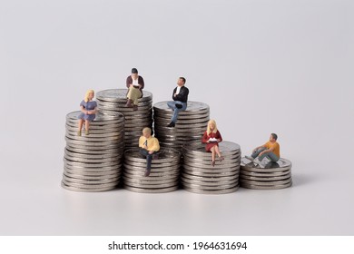 Miniature people - Business people are sitting on the coins, Business Growth concept, white background - Shutterstock ID 1964631694