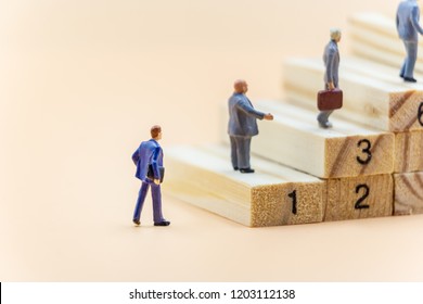 Miniature people Businessman walk up stair - Shutterstock ID 1203112138