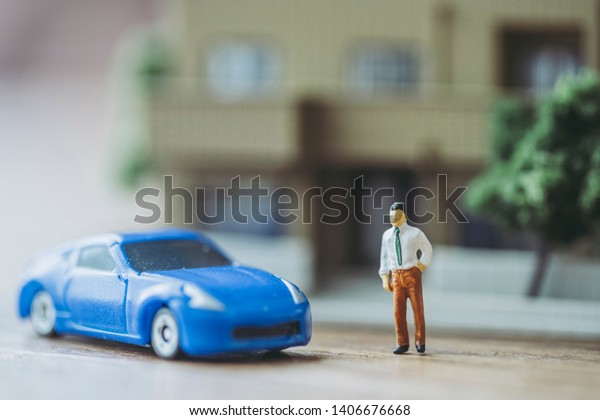 Miniature people and cars who\
live