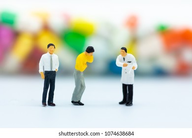Miniature people: Check your health with doctor. Image use for drug, pills, capsules ,Health and medicine concept.