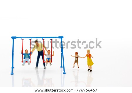 Miniature people, children and family enjoy with swing , happy family day concept.

