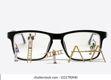 Miniature People Cleaning The Eyeglasses