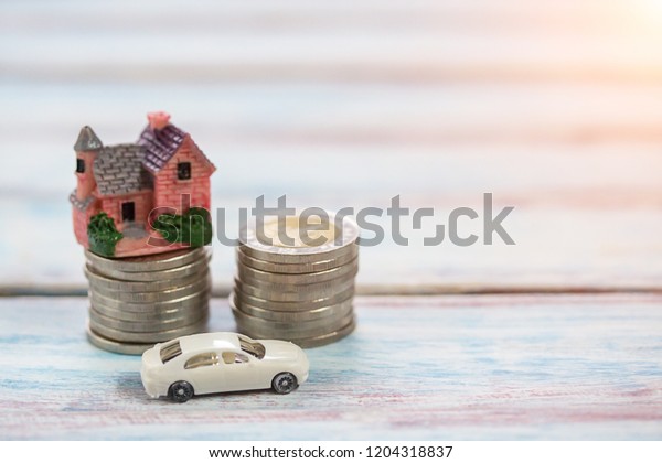 Miniature people: Coin money and toy car.\
Concept of Financial and money.Office desk with money coins and\
business financial\
planning.