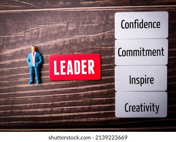 Miniature people and colored board with great Leader attributes. - Shutterstock ID 2139223669