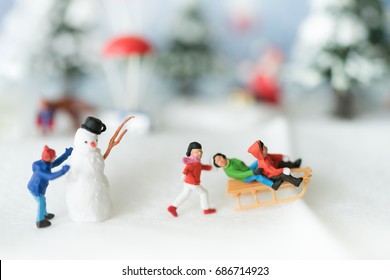 Miniature people: Colorful Christmas characters and decorations. Using as background or wallpaper holiday concept.
