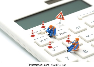 Miniature People Construction Worker Keypad TAX Button For Tax Calculation. Easy To Calculate. On White Calculator On White Background Using As Background Business Concept And With Copy Space. 