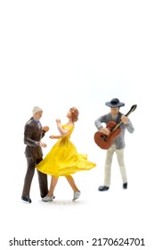Miniature people Couple dancing with a guitarist playing the guitar on white background - Shutterstock ID 2170624701