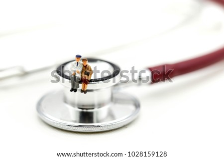 Miniature people : Couple of oldman sitting with medical stethoscope,heathcare concept.