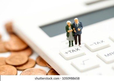 Miniature people : Couple oldman standing with Calculator,business,tax concept. - Shutterstock ID 1050988658