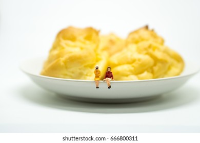 Miniature People Couple Woman Sitting On Chu Cream With Isolated On White Background