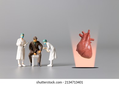 Miniature People , Doctor Studying And Treating Human Heart  , World Health Day Concept