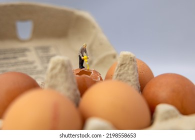 Miniature People With A Drill On An Egg