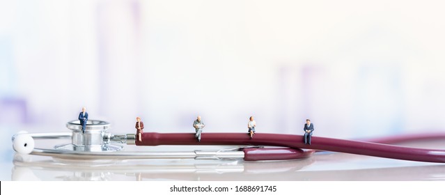Miniature People: Elderly People Sitting On Stethoscope. Social Security Income And Pensions. Health Care Inequality. Time Counting Down For Retirement Concept. Social Distancing.