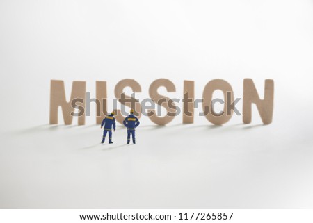Miniature people: Engineer standing infront to seeing on MISSION word use as businessconcept concept.