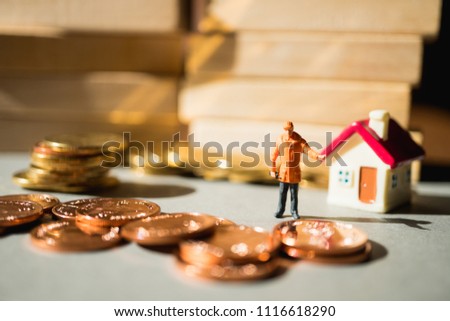 Miniature people, engineer standing with stack coins and mini house using as business, industry and financial concept