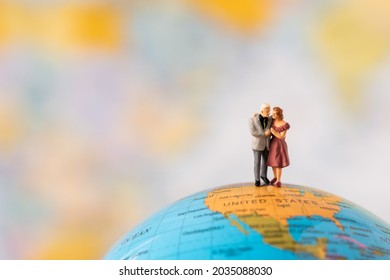 Miniature People Family Father Mother And Children Standing On Global World Map With Happiness Using For Travel Around The World Business Trip Traveler Adviser Agency Or Online World Wide Marketing 