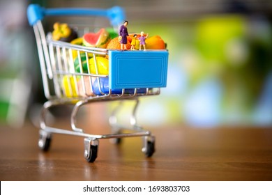 Miniature People Of Family And Shopping Cart In Supermarket.food And Beverage Concept