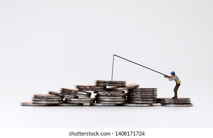 Miniature people fishing with coin piles.