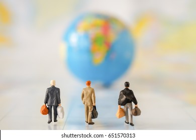 Miniature people: Group of Businessman mini figures walking to Global Balloon Map Model on world map with Copyspace. Success Business Due around the world and Travelling agency concepts.