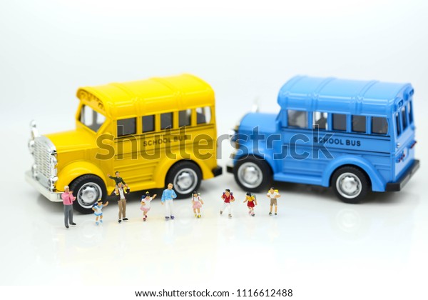 Miniature\
people : A group of young children getting on the\
schoolbus,schoolbus transportation\
education