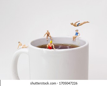 Miniature People Hanging Around A Coffee Cup